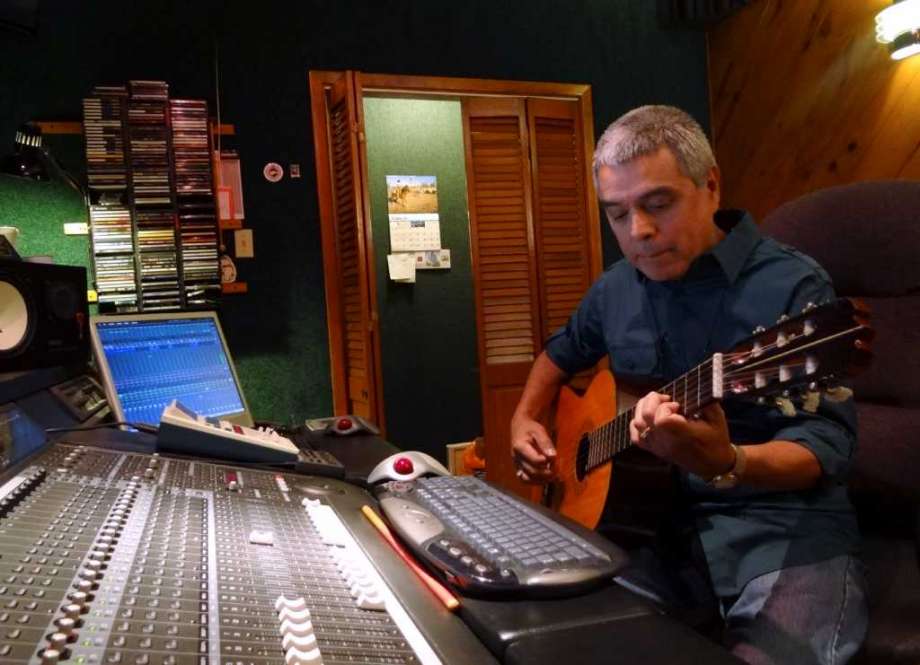 Grammy-winning producer/engineer and musician Gilbert Velasquez plays guitar in his recording studio. He has had a hand in several recent Grammy projects. BILLY CALZADA / EXPRESS-NEWS Photo: BILLY CALZADA, STAFF / gcalzada@express-news.net